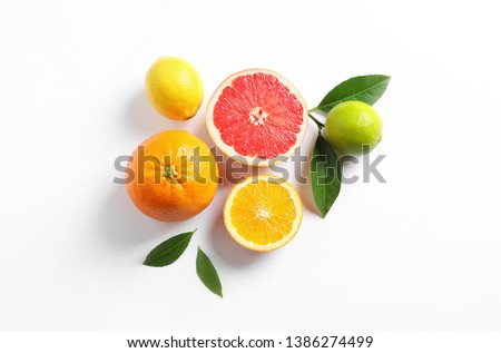 Flat lay composition with different citrus fruits on white background Royalty-Free Stock Photo #1386274499