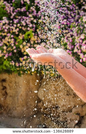 Human hands with drops of water