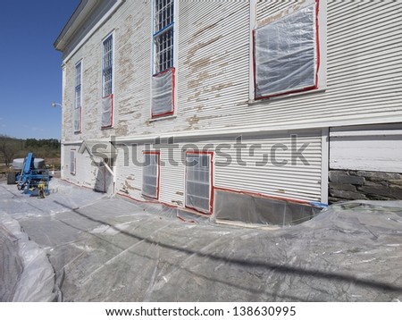 Lead paint removal on an old church siding Royalty-Free Stock Photo #138630995