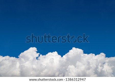 Background, clear blue sky and white cumulus fluffy clouds on the bottom edge