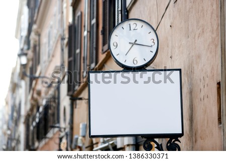 Street clock and empty rectangular blank sign on the street in the city - Image