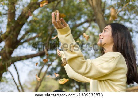 Picture beautiful of Asian woman smiling happy at autumn ,portrait at outdoor in park 