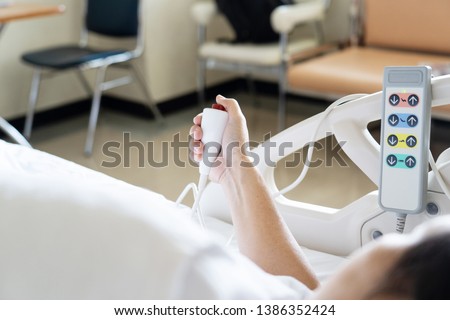 View of patient press red emergency button to calling nurse for help in hospital. Royalty-Free Stock Photo #1386352424