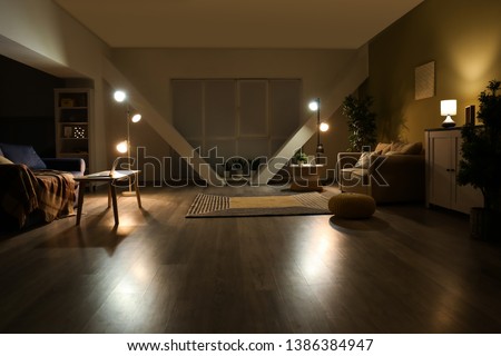 Stylish interior of living room at night Royalty-Free Stock Photo #1386384947