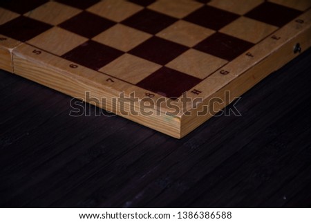 Wooden chess board on black background.