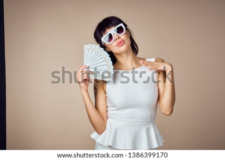     business woman with glasses holds money dollars                           
