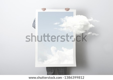 think outside the box, surreal concept of a clouds getting out of a poster