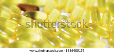 Medical medicines and supplements transparent capsules of yellow color
