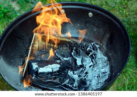 Fire, hot grilling. Barbecue grill with fire on nature, outdoor,top view