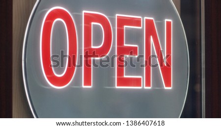 Business sign OPEN. Red large illuminated letters.