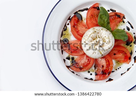 tomatoes with burrata and balsamic on white background Royalty-Free Stock Photo #1386422780