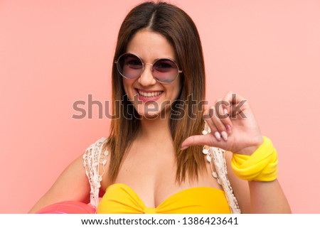 Young woman in bikini in summer holidays proud and self-satisfied