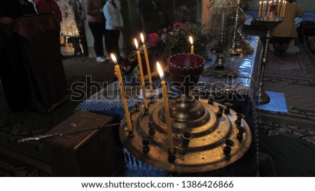 candles lit on a candlestick in the Orthodox Church