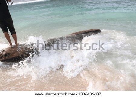 the waves that hit the wood on the Teluk Asmara Beach, Malang - East Java, Indonesia.