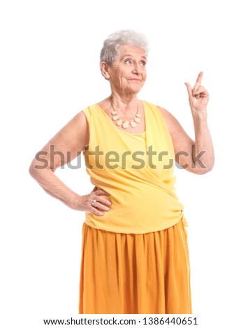 Portrait of senior woman with raised index finger on white background