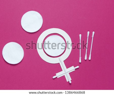 Products for feminine hygiene, self-care and health, female gender symbol on a red background. Ear sticks, pads. Top view