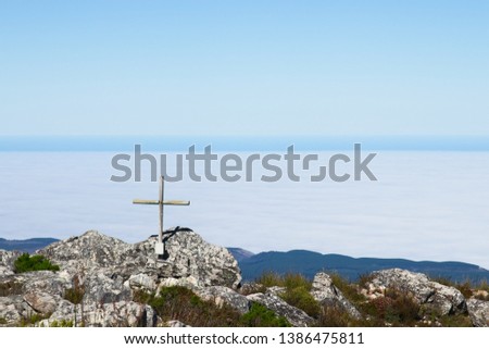 A wooden cross on top of Formosa mountain peak near Plettenberg Bay, South Africa. Christianity religion concept image. 