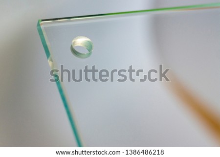 Transparent glass plate with holes