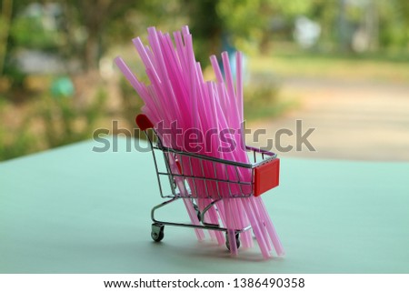 Close-up picture of pink plastic tube isolated in a shopping cart  Natural green paper background blur