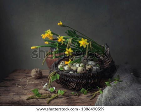Still life with bouquet of daffodil flowers and quail eggs