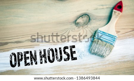 Open House. paintbrush with white color on a wooden background