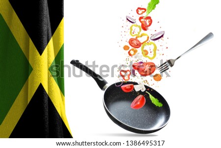 Frying pan with falling vegetables, isolated. On the background of the flag of Jamaica