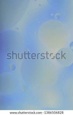 Blurred abstract background. Blue and light blue circles and wavy lines of different sizes on a gray background. Cropped shot, vertical, a lot of free space, nobody. Concept of design.