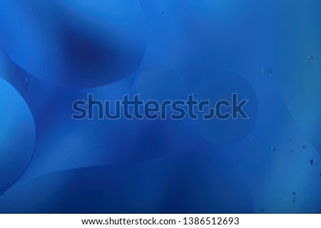 Blurred abstract background. Blue and light blue circles and wavy lines of different sizes. Cropped shot, horizontal, a lot of free space, nobody. The concept of design.