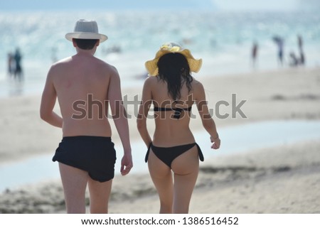 Couple on a tropical beach Happy and enjoys  tropical on beach vacation. Summer beach relaxation vacation concept.