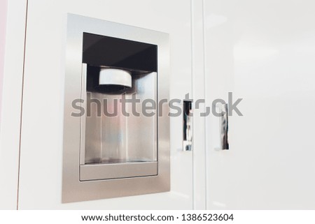 Refrigerator Ice and Water Dispenser modern front design close-up.