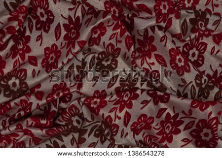 Detail of white fabric with red floral patterns