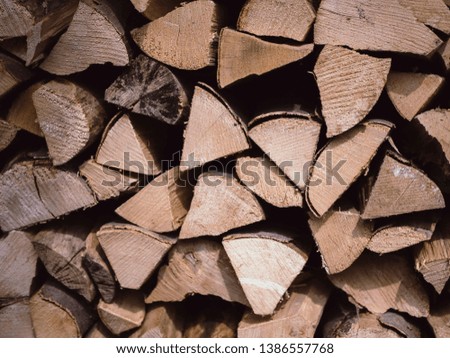 Stacked chopped wood. Closeup picture of the pile with different shaped pieces. Raw material which has been sliced after it has been chopped. 