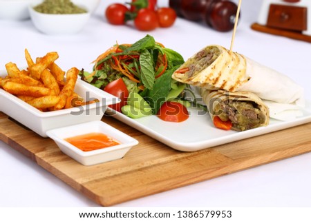 Mexican beef steak burritos with french fries and vegetable