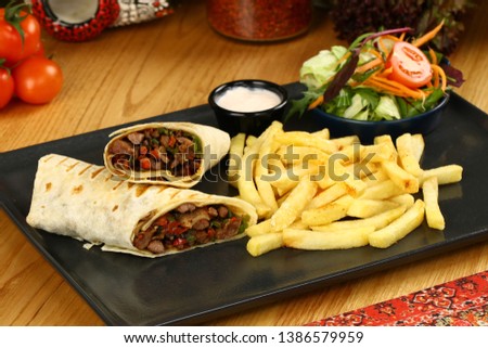 Mexican beef steak burritos with french fries and vegetable