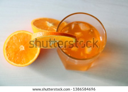 Orange fresh drink, glass of  orange juice and ripe citrus fruits on white background