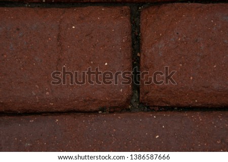 Closeup red brick cobblestone abstract texture background with dirt and detail.