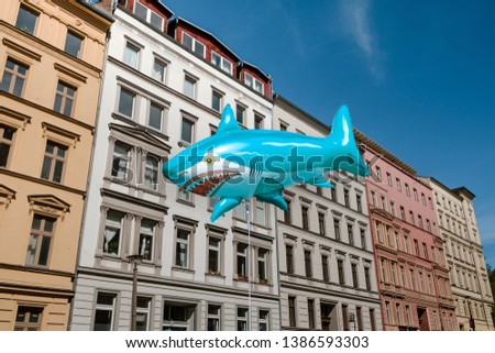 Shark ballon with real estate building facade background