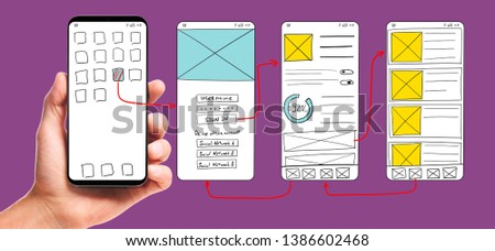 UI development. Male hand holding smartphone with wireframed user interface screen prototypes of a mobile application on white background.