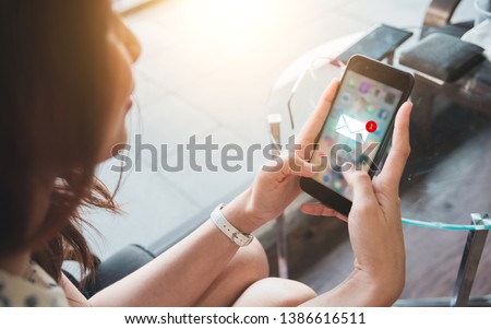 Women are watching the smartphone because they have received inbox email, New messages on mobile smartphone. Royalty-Free Stock Photo #1386616511