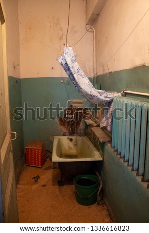 Old emergency room in disrepair in an old communal apartment where three families live in St. Petersburg in Russia Royalty-Free Stock Photo #1386616823