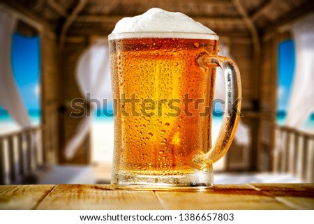 Summer beer on table and beach landscape 