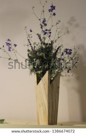 Blue field flowers in a wooden vase