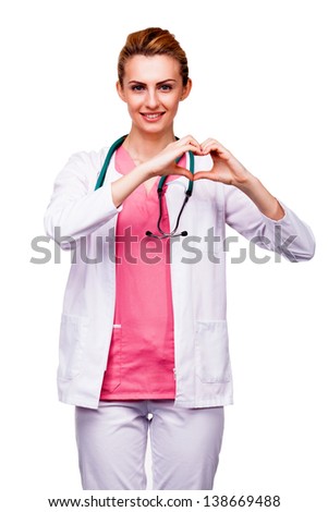 young doctor showing heart sign on white background