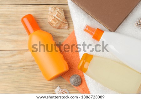 Sunscreen. various sunscreens and beach, summer accessories on a natural wooden background. summer. vacation. Sun protection. top view