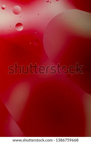 Blurred abstract background. Red with white circles and wavy lines of different sizes. Cropped shot, vertical, a lot of free space, nobody. Concept of design.