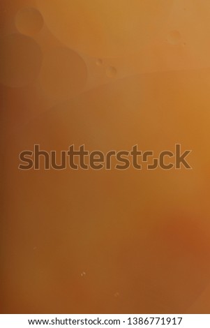 Blurred abstract background. Orange circles and wavy lines of different sizes. Cropped shot, vertical, a lot of free space, nobody. Concept of design.