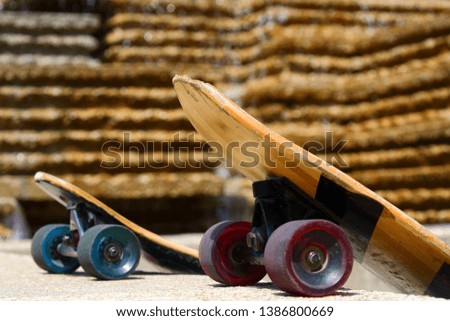 two worn skate boards with fountain in back round