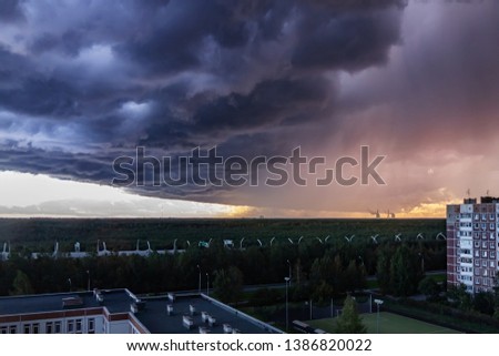 huge thundercloud on the outskirts of the city before the rain - image