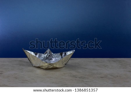 paper boat made of aluminum foil. A romantic journey at a beautiful night