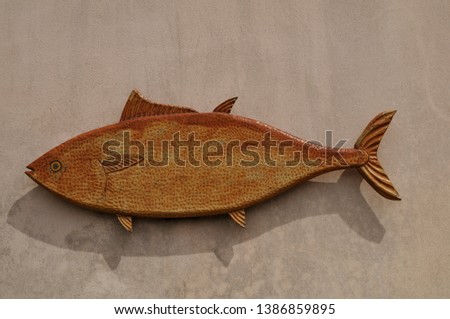 Fish shape of clay on the wall with text space for your logo
